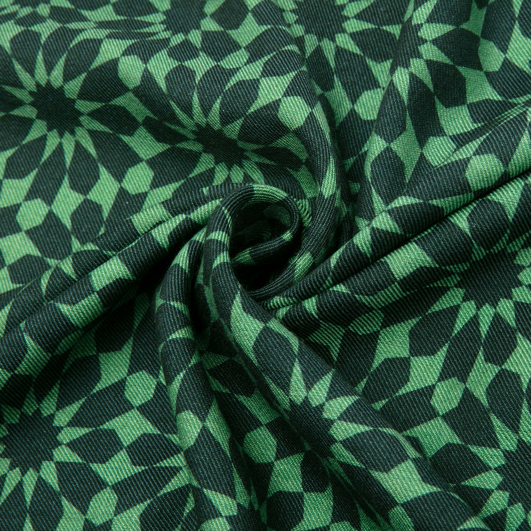 The Silk and Wool Green Scarf Dinah V1 by Hamzah features an Islamic geometry print with overlapping shapes and intricate designs. Gently twisted at the center, this luxurious accessory adds depth and texture to any outfit.