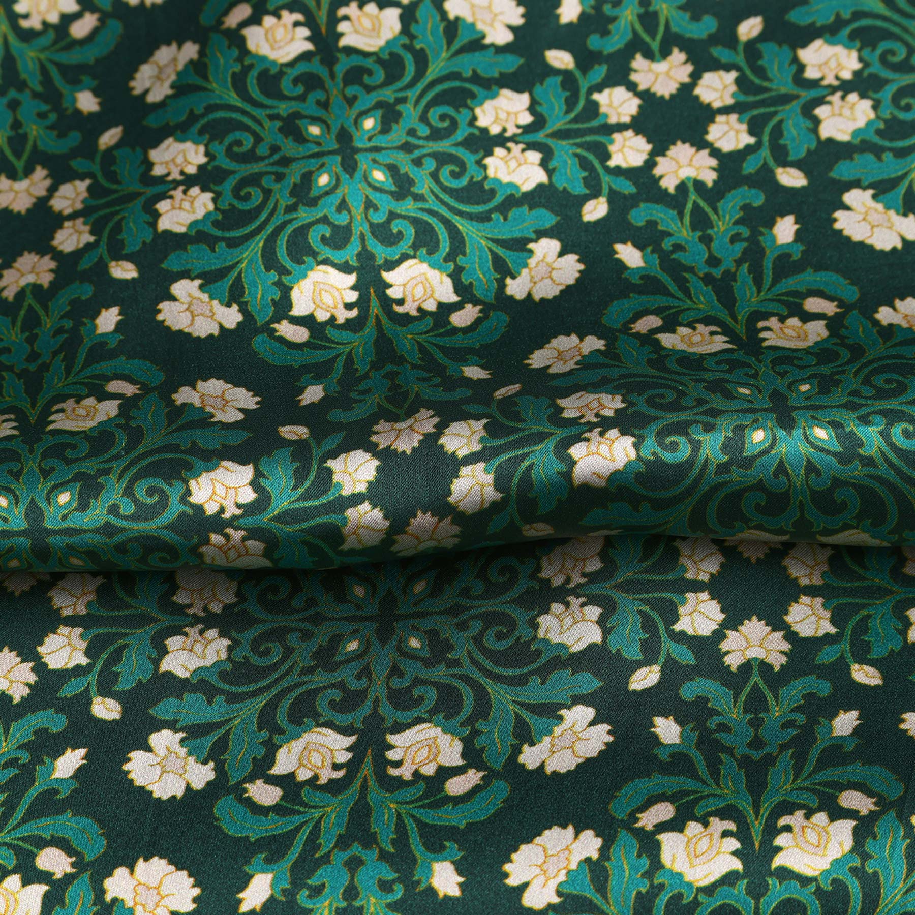 The Floral Green Silk Scarf with Delicate White Blooms comes in elegant black packaging labeled HAMZAH at the top and “Wrap