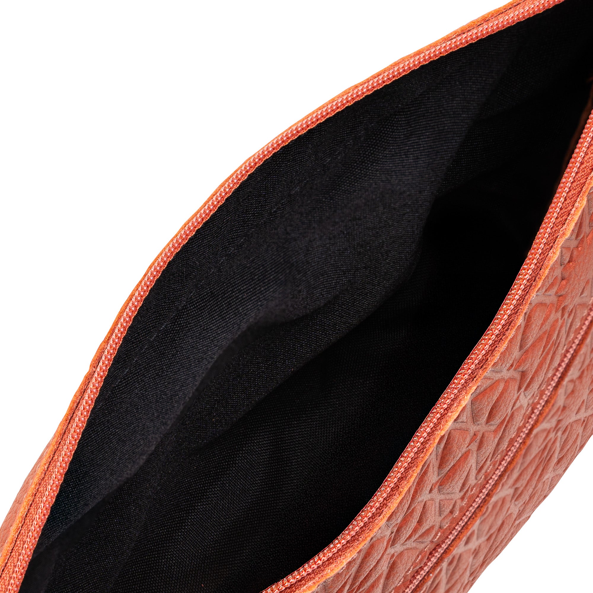 Top view of the Coral Embossed Crossbody Bag with Islamic Design Pattern, featuring an orange textured zippered pouch and black inner lining, shown partially open.