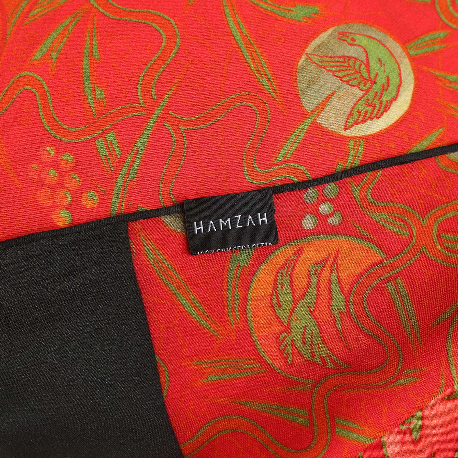 A rectangular gift box with HAMZAH at the top displays the Red Silk Scarf with Abstract Floral Print Kabuki in vibrant hues