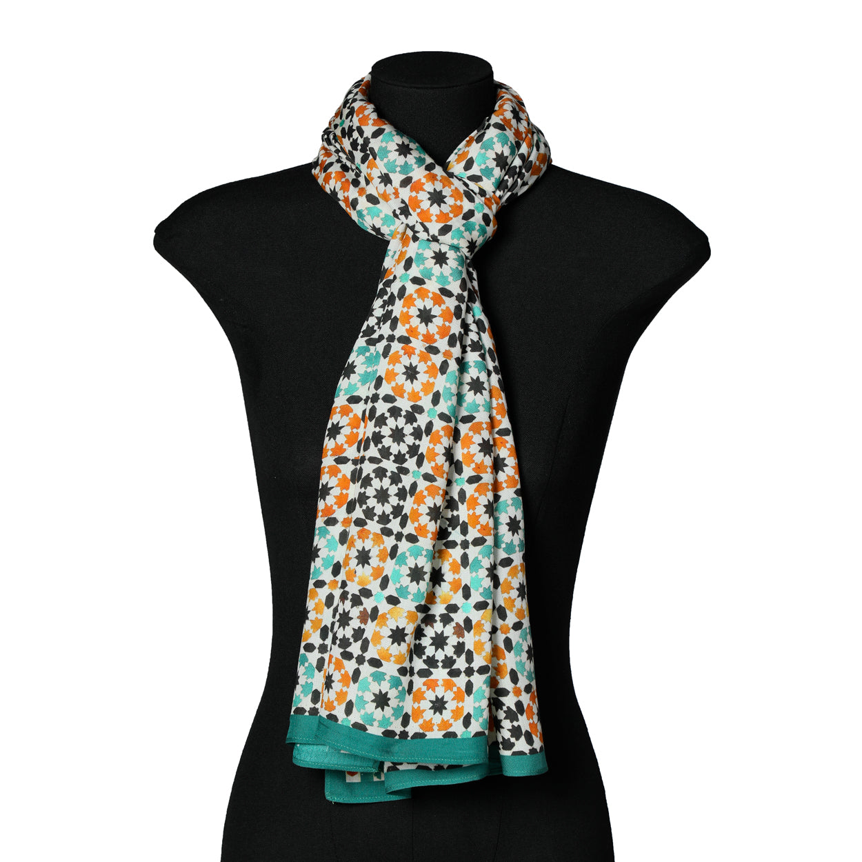 Mannequin wearing green and orange Islamic art-inspired scarf.