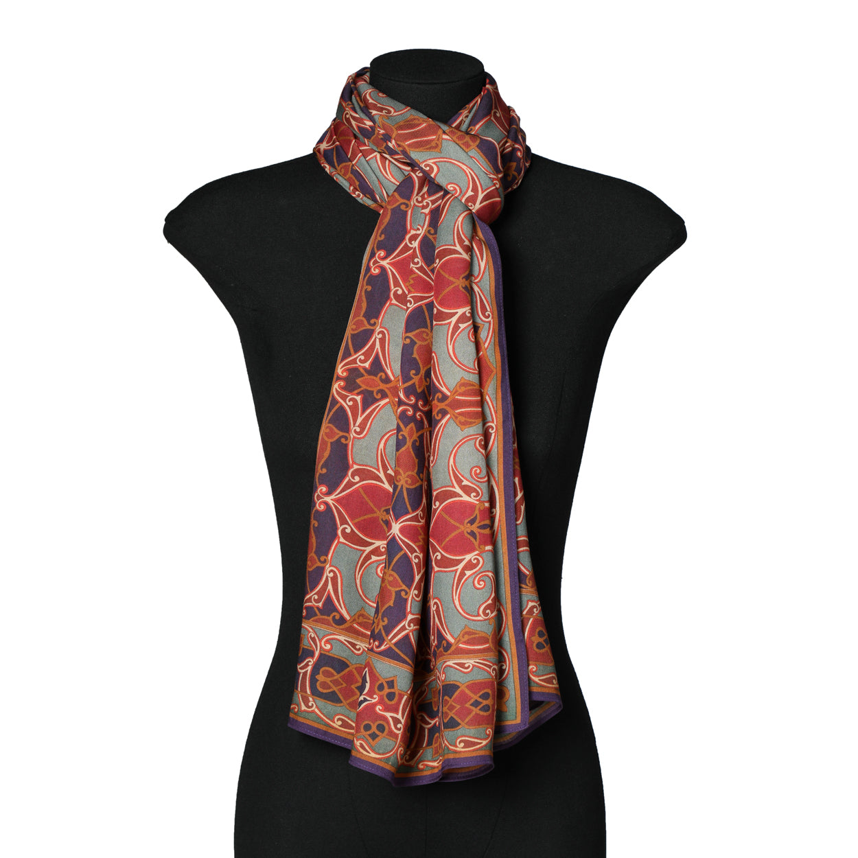 Mannequin wearing red and blue scarf inspired by Islamic art.