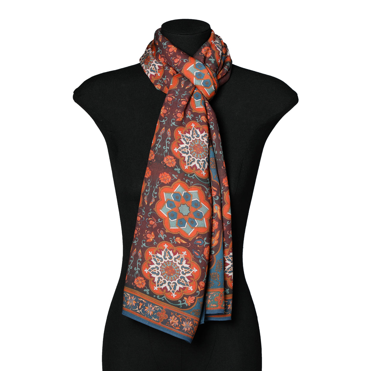 Mannequin styled with Islamic art-inspired red and blue scarf.
