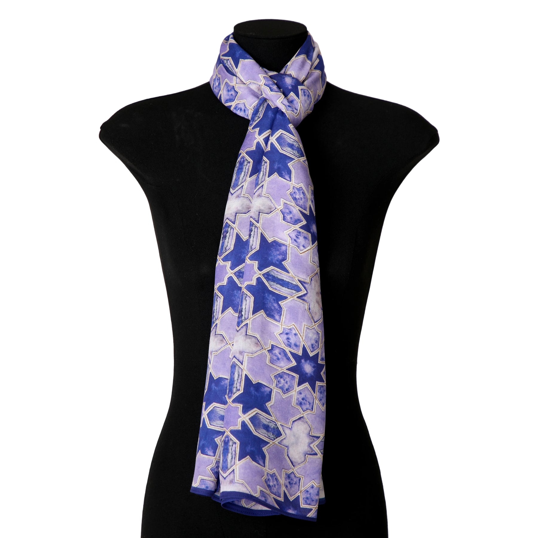 The Purple Scarf for Women - 100% Modal, featuring a purple and blue geometric star pattern inspired by Islamic design, is displayed draped around the neck of a black dress form mannequin.