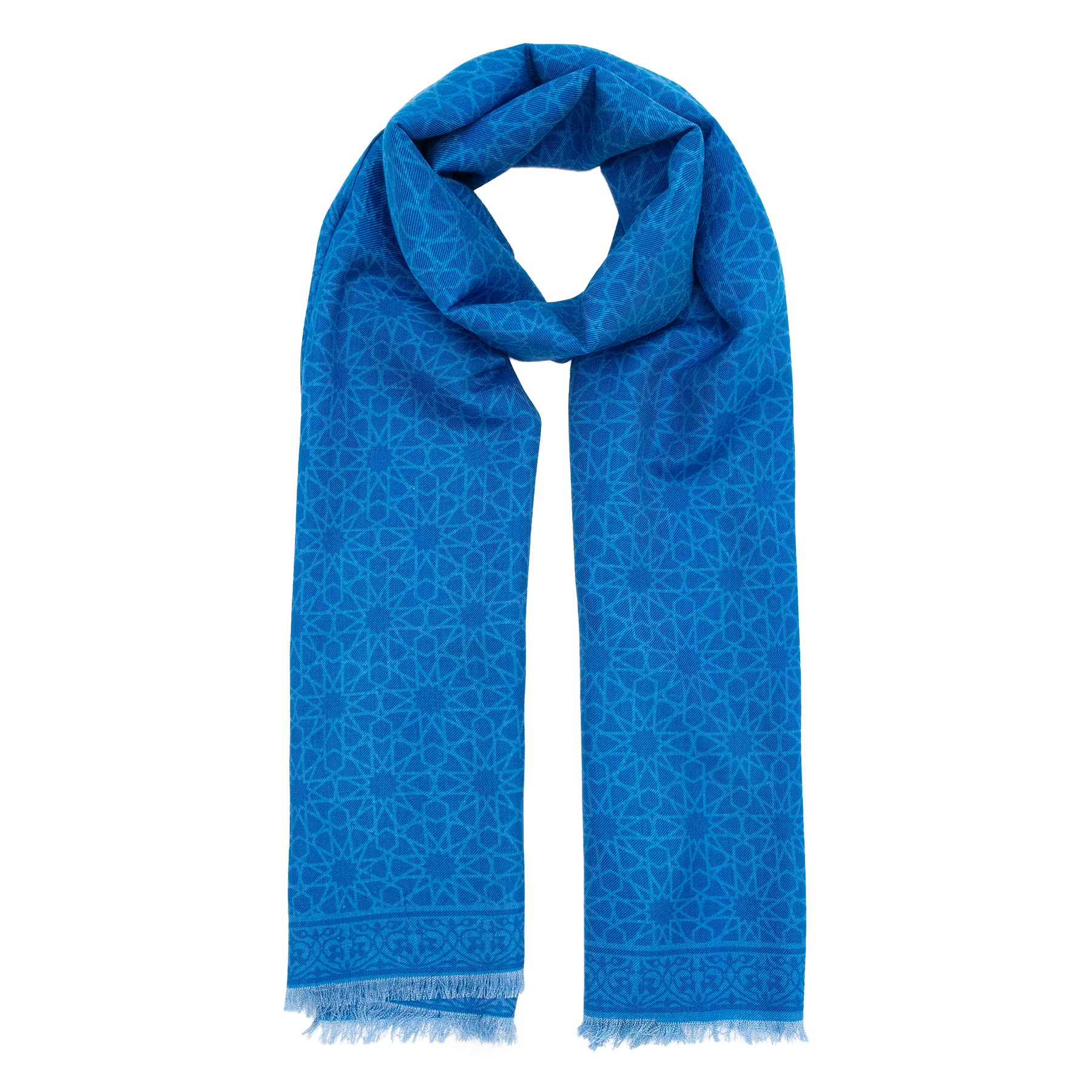 The Hamzah Silk and Wool Blue Scarf Dalila features a luxurious blend with an intricate geometric multicolor print. Neatly folded with fringed edges, this elegant accessory provides warmth and style.