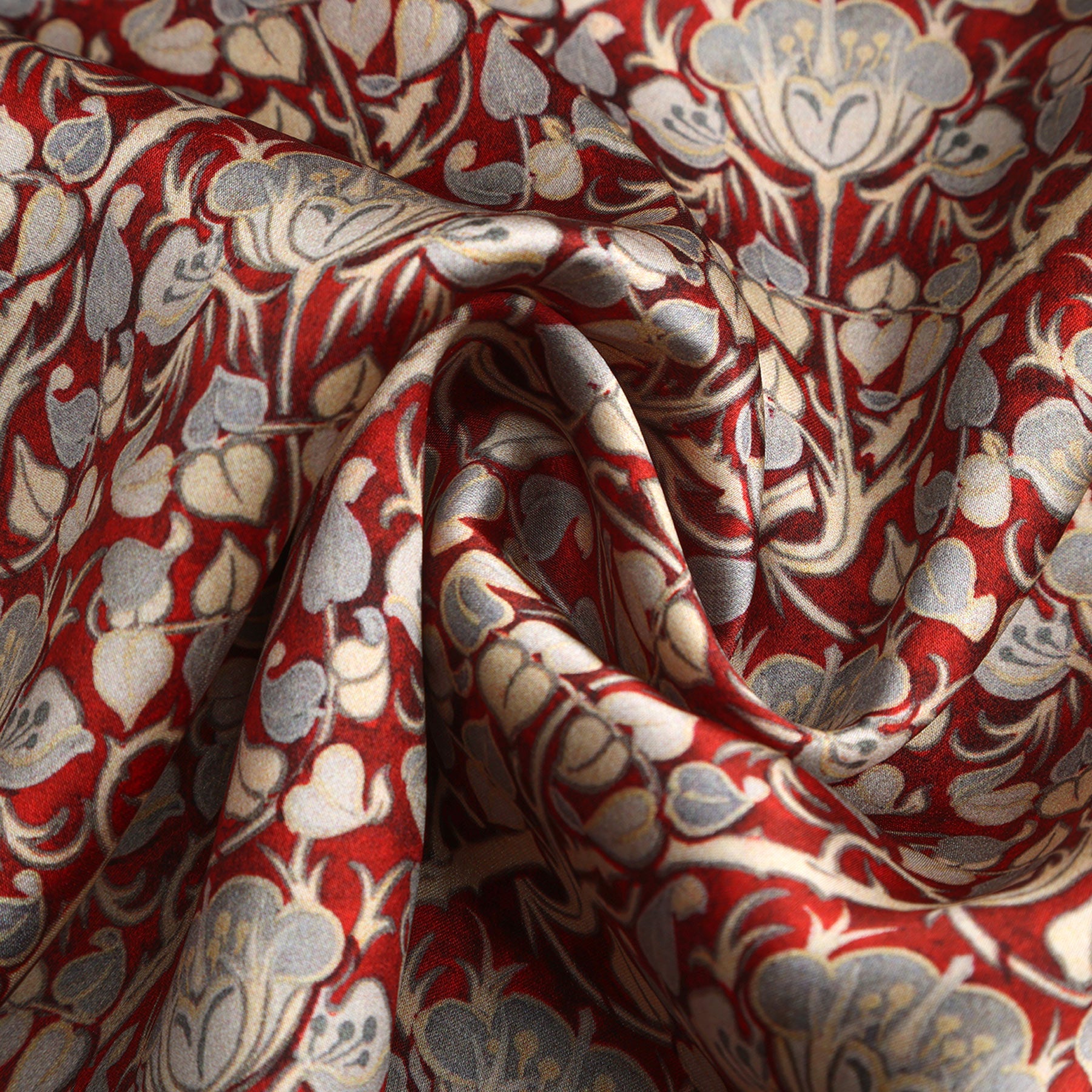 Burgundy and gray silk scarf with a Noisette roses print, featuring softly gathered folds and a spiral design that evokes the elegance of Art Nouveau.