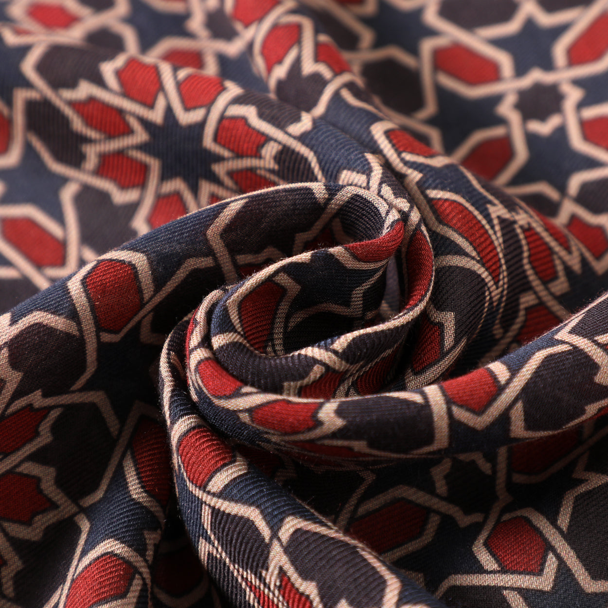 Close-up texture of navy blue and red geometric scarf design