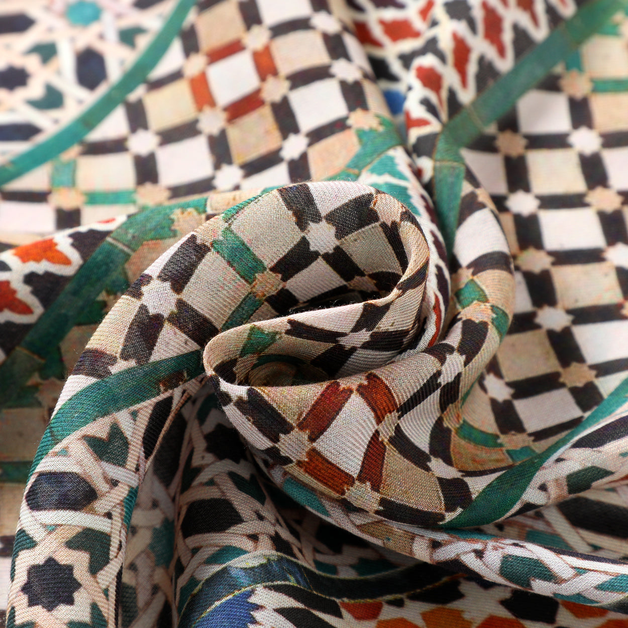 Close-up of scarf fabric showcasing detailed mosaic tile patterns in multicolor design inspired by Islamic art