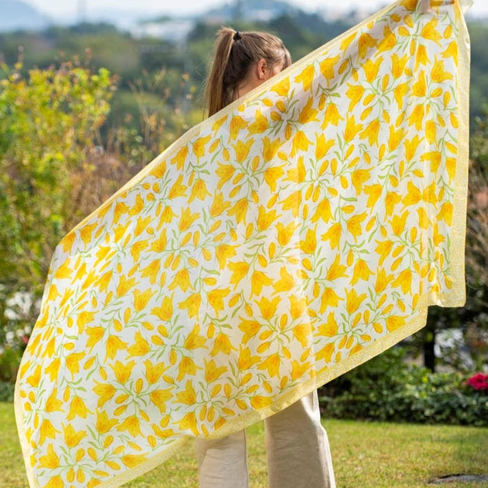 Woman with yellow silk scarf with floral print