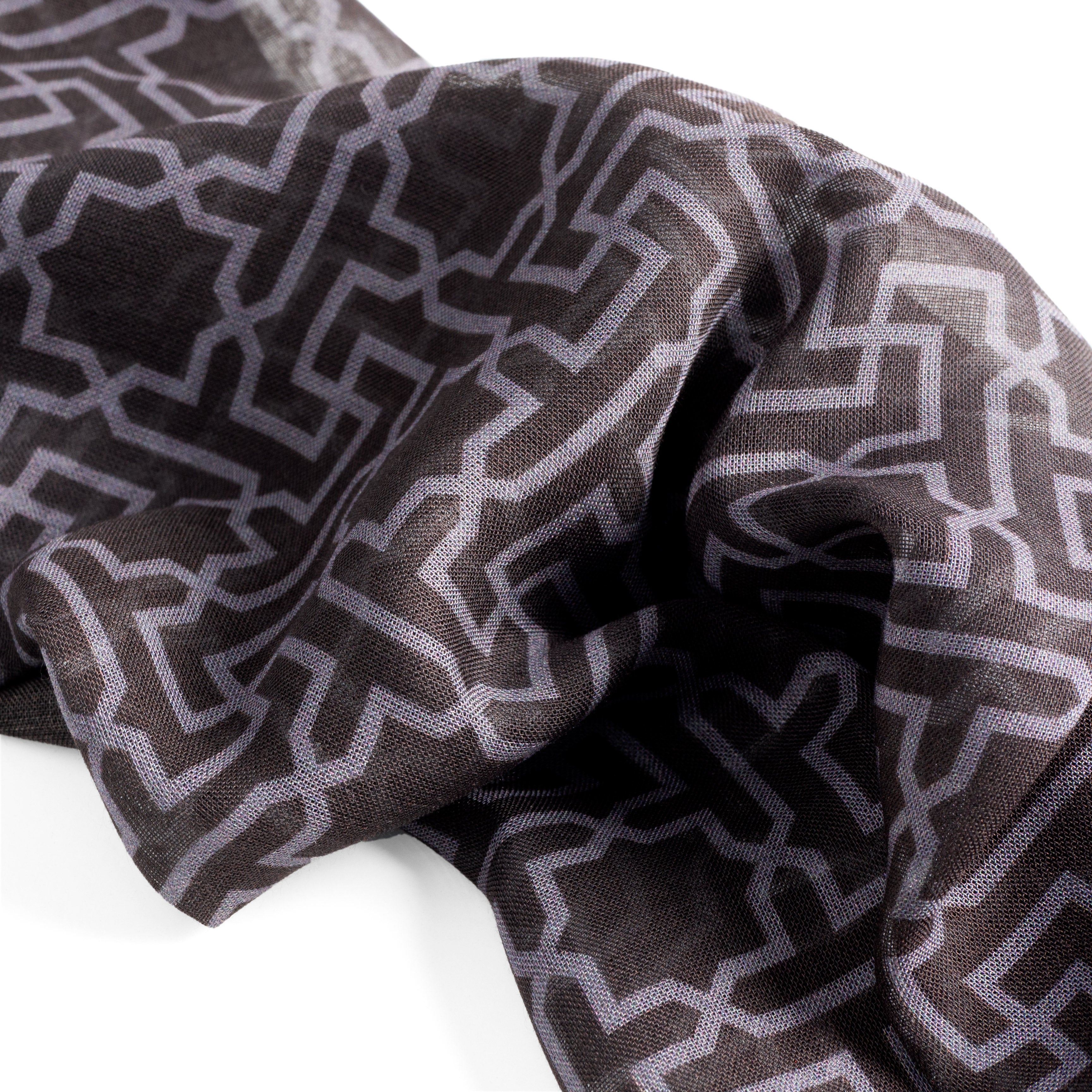 Black and gray scarf detail with geometric print inspired by islamic art