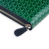 Detail of green leather wallet with zipper and embossed design of flower of life