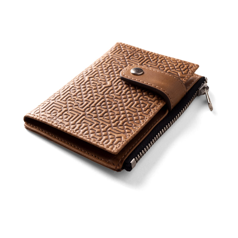 Detail of embossed brown slim leather wallet inspired by islamic art