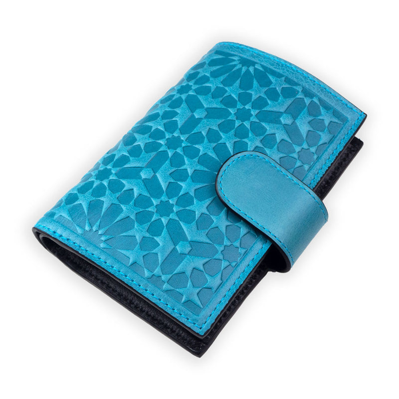 Women's blue leather wallet with strap closure and islamic geometry inspired embossed pattern