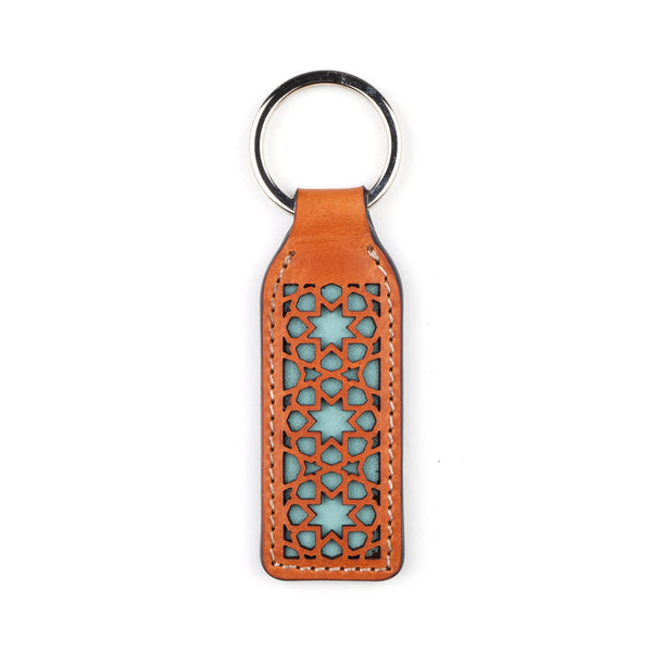 Light blue and brown laser cut leather keychain with islamic art inspired pattern