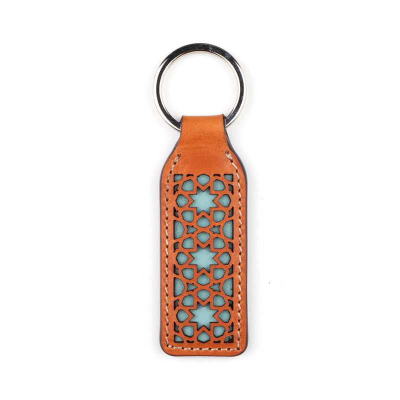 Light blue and brown laser cut leather keychain with islamic art inspired pattern