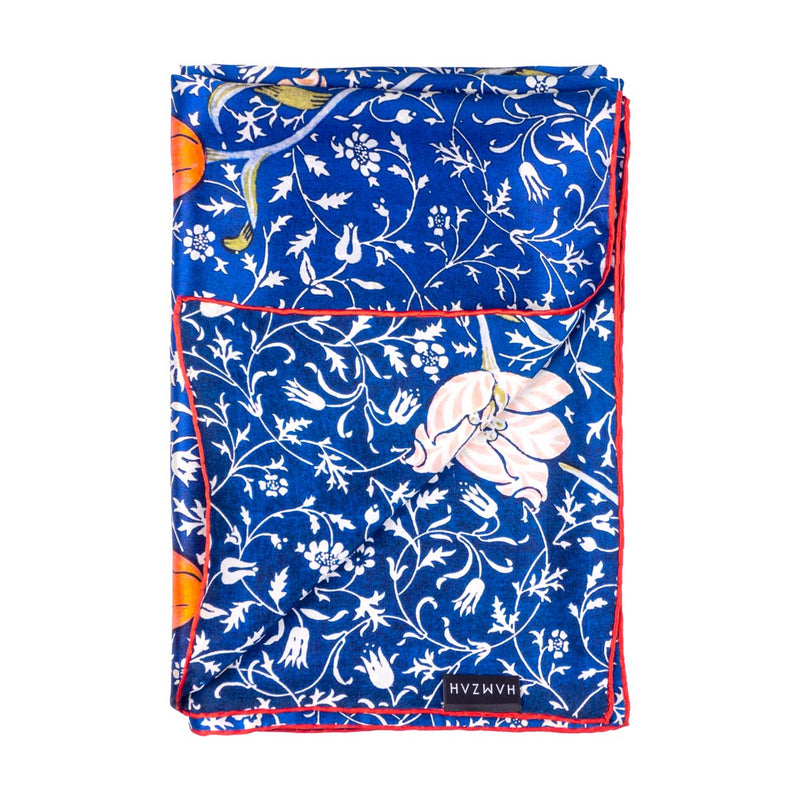 Close up of hand-rolled blue silk scarf with floral print