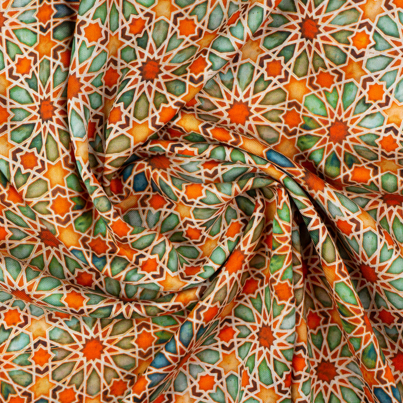 Detail of orange and green scarf featuring islamic art print