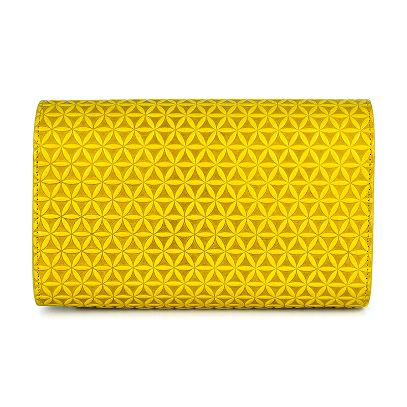 Detail of small leather clutch bag with flower of life pattern