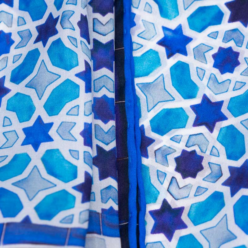 Detail of light blue silk scarf featuring islamic art geometric print