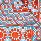 Close up of red and blue silk scarf with islamic art print