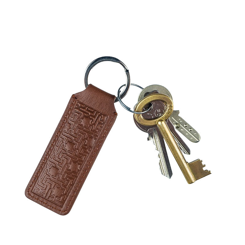 Brown leather keychain with islamic art pattern